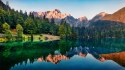 Fototapeta Calm Morning View Of Fusine Lake. Colorful Summer Sunrise In Julian Alps With Mangart Peak On Background, Province Of