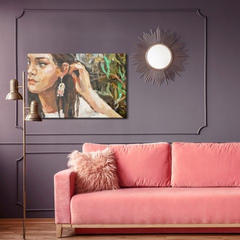 Obraz Na Płótnie A Young Girl Is Sitting In An Ethnic White Dress. The Background Depicts An Autumn Field With Flowers And Herbs