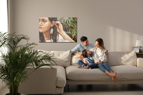 Obraz Na Płótnie A Young Girl Is Sitting In An Ethnic White Dress. The Background Depicts An Autumn Field With Flowers And Herbs